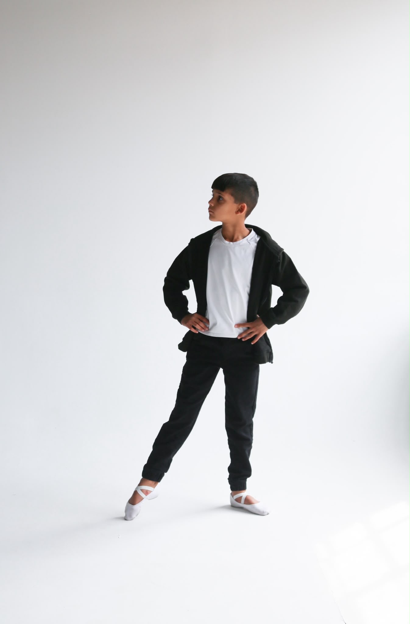 Aairun posing in ballet shoes against a white studio background