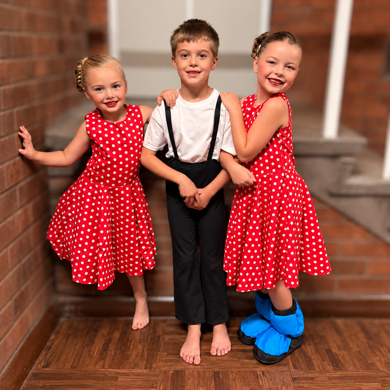 Edward with two dance friends in their performance costumes, with the background softly blurred