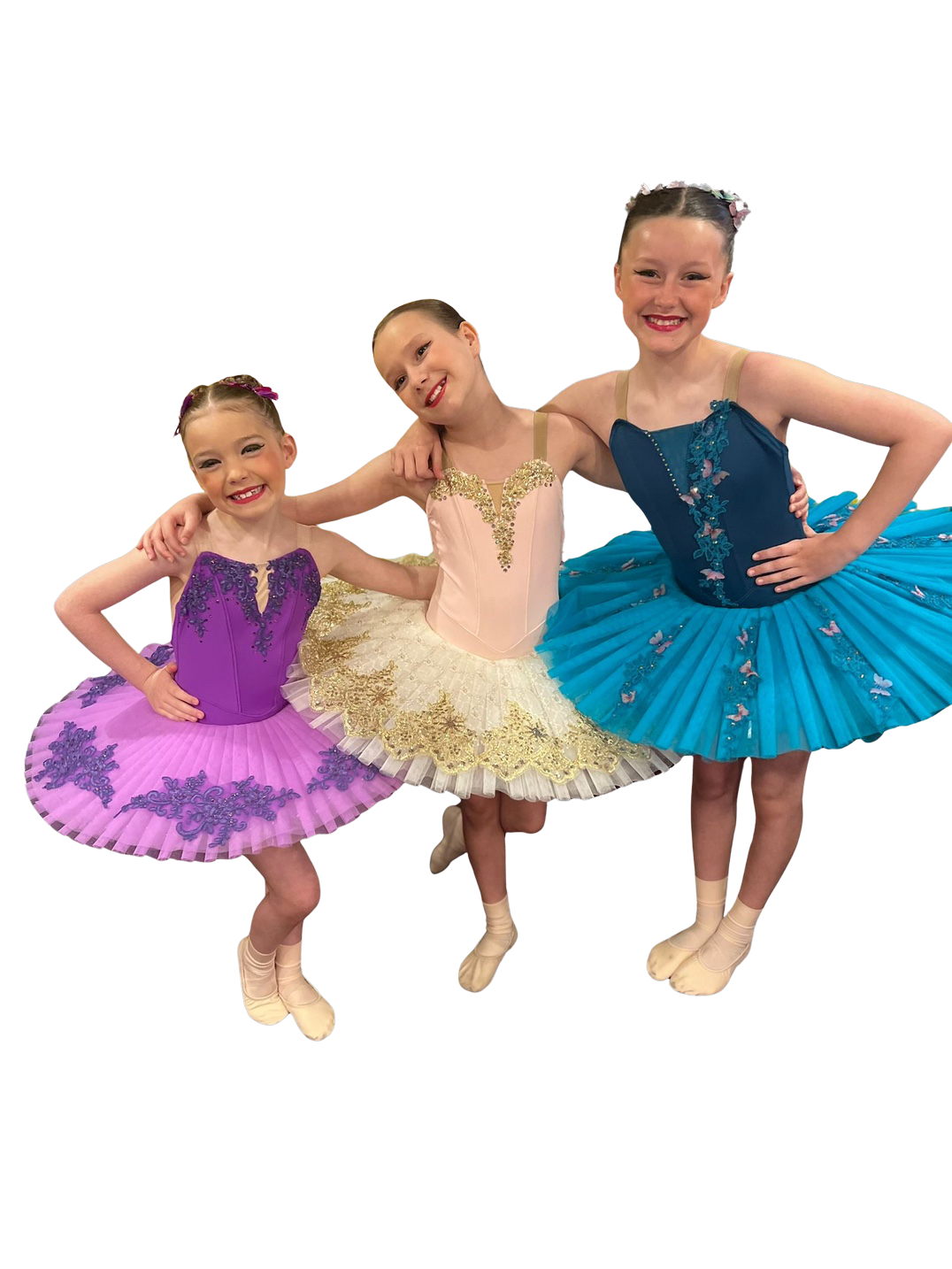 Three smiling LHTS pupils in colourful ballet performance costumes