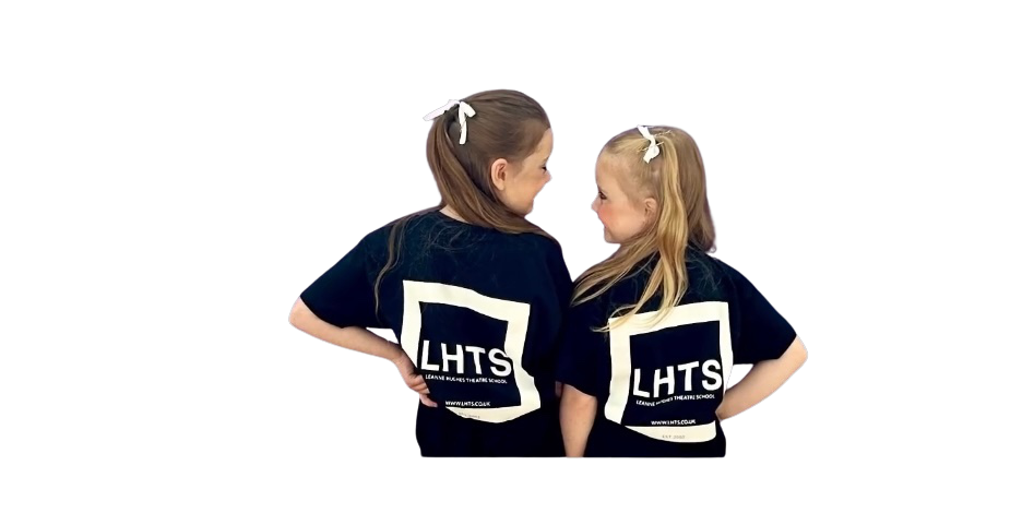 Two LHTS girls turned towards each other, showing the school logo on the backs of their T-shirts